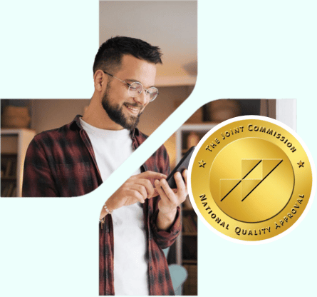 Man talking on smartphone with The Joint Commission Accredited seal displayed